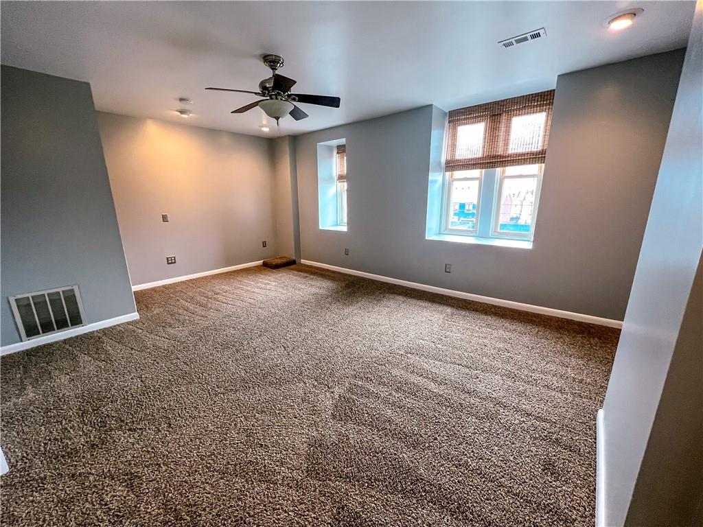2414 East Carson Street, Unit 2 Pittsburgh, PA 15203 - Photo 12 of 15 an empty room with windows and fan