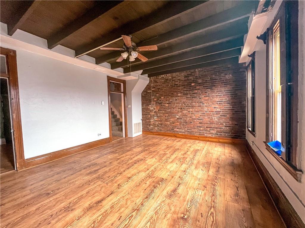 2414 East Carson Street, Unit 2 Pittsburgh, PA 15203 - Photo 3 of 15 a view of an empty room with wooden floor and a window