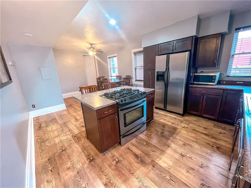 2414 East Carson Street, Unit 2 Pittsburgh, PA 15203 - Photo 6 of 15 a kitchen with stainless steel appliances granite countertop a sink stove and refrigerator