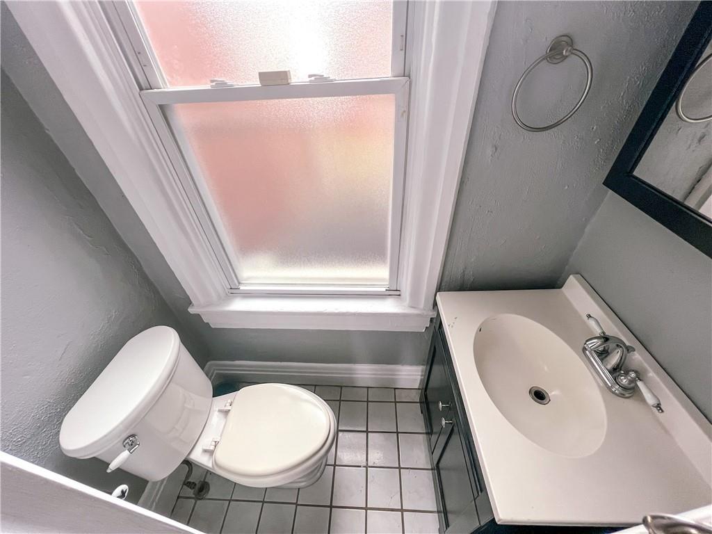 2414 East Carson Street, Unit 2 Pittsburgh, PA 15203 - Photo 9 of 15 a bathroom with a sink a toilet and a mirror