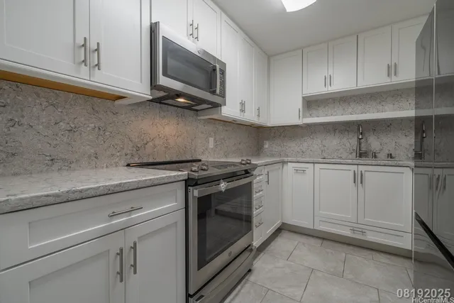 a kitchen with white cabinets and a sink