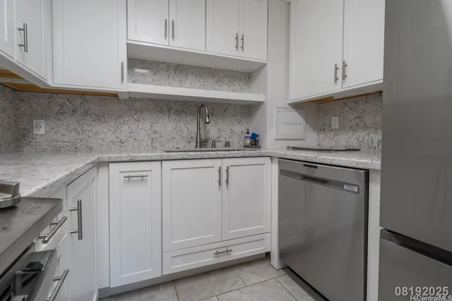 a kitchen with white cabinets and white appliances