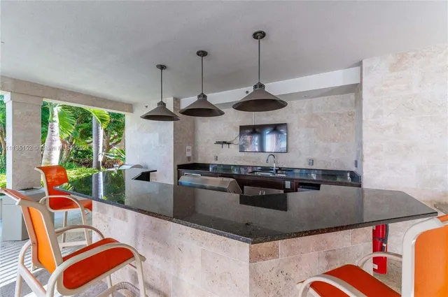 a room with lots of tables a large window and chairs