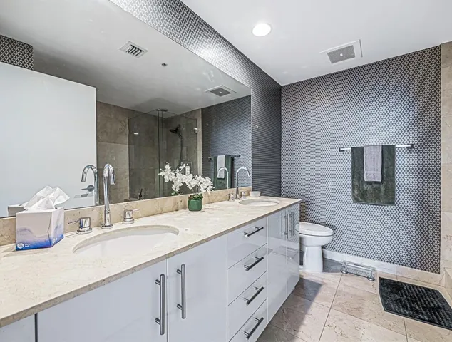 a kitchen with stainless steel appliances granite countertop a stove and a sink
