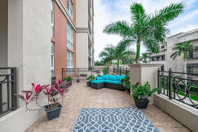 a living room with furniture a flat screen tv and a large window