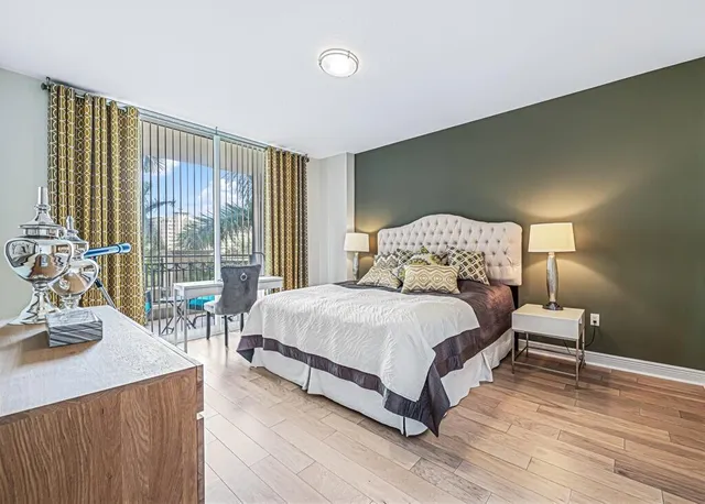 a bathroom with a tub a mirror and shower