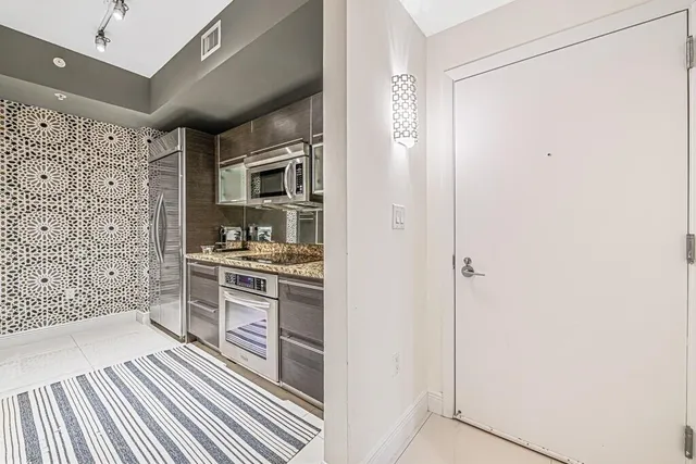 a kitchen with granite countertop a sink and cabinets