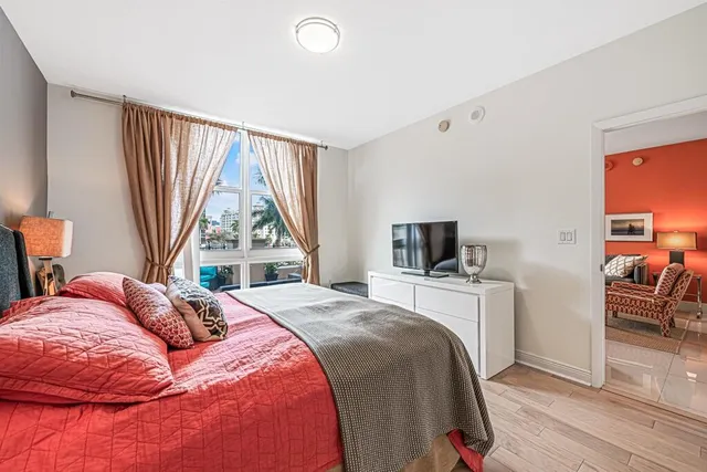 a bedroom with a bed and a large window