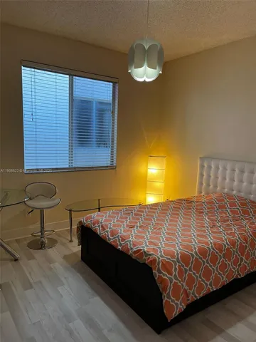 a bedroom with a bed and a table in it