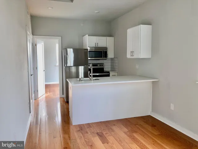 a view of kitchen and wooden floor
