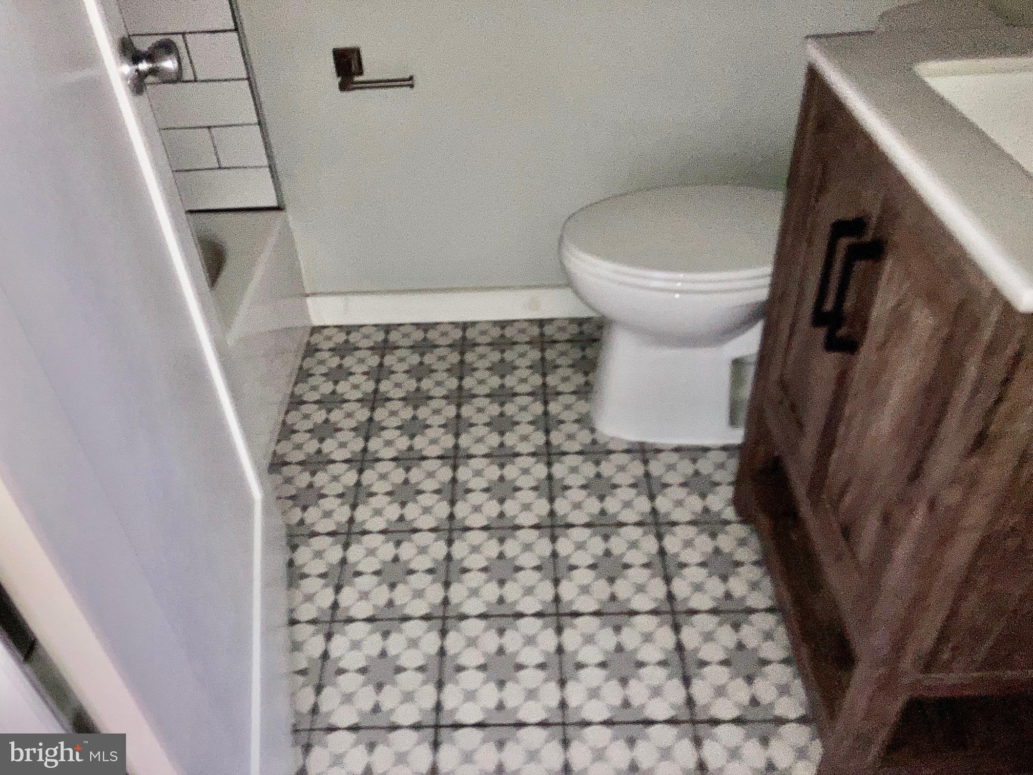 5358 Addison Street, Unit 2 Philadelphia, PA 19143 - Photo 13 of 13 a bathroom with a sink and a toilet