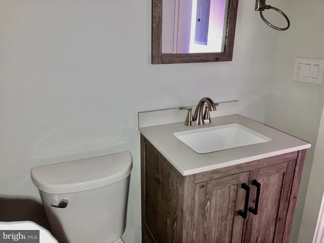 a bathroom with a sink toilet and a mirror