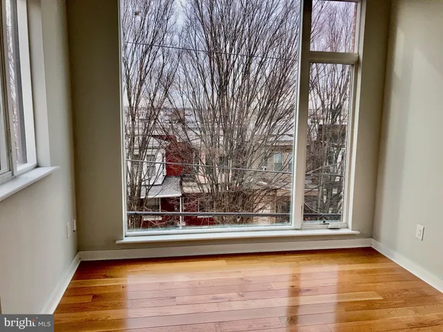 a view of a living room area with furniture and wooden floor