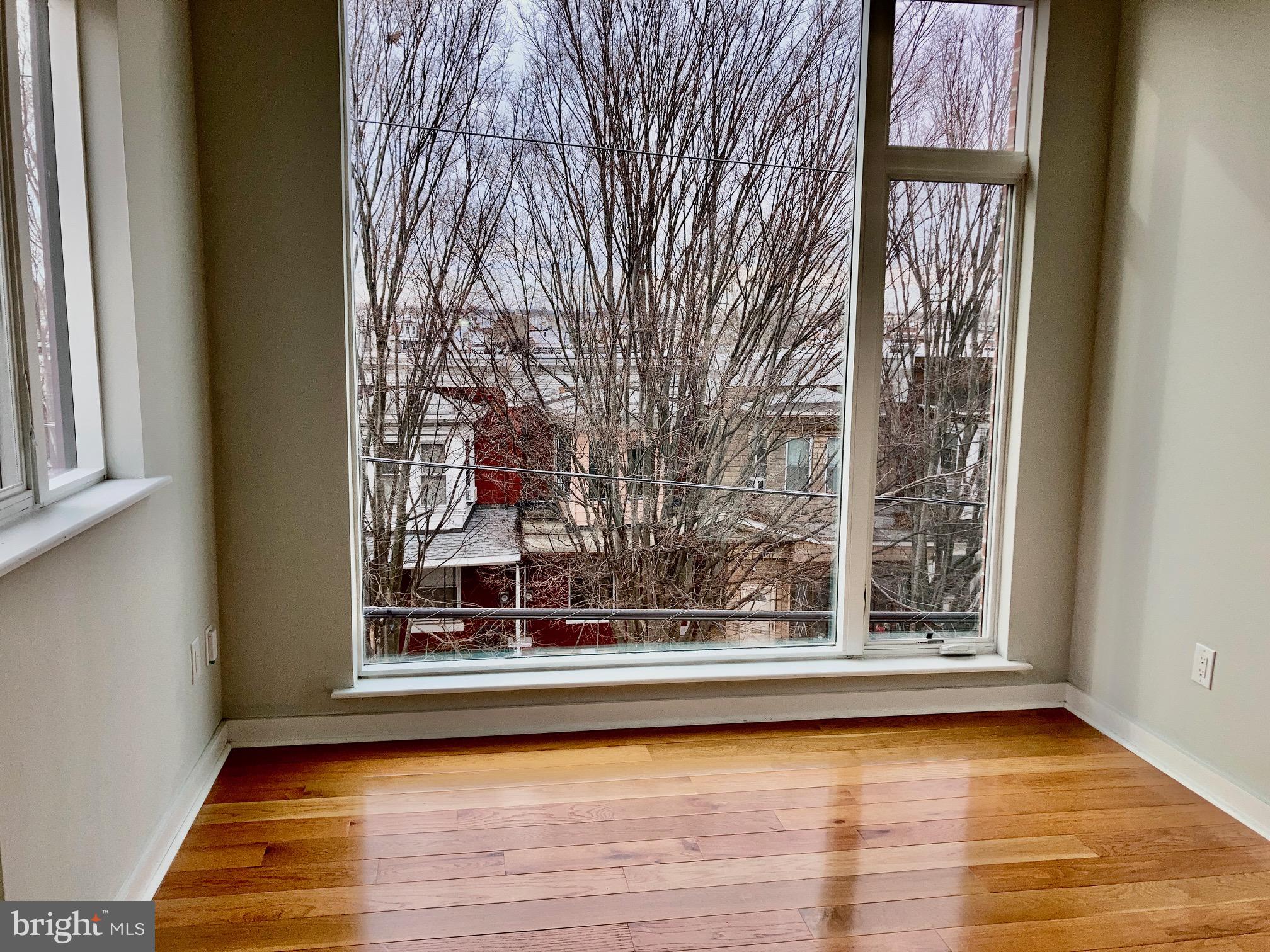 5358 Addison Street, Unit 2 Philadelphia, PA 19143 - Photo 7 of 13 a view of a living room area with furniture and wooden floor