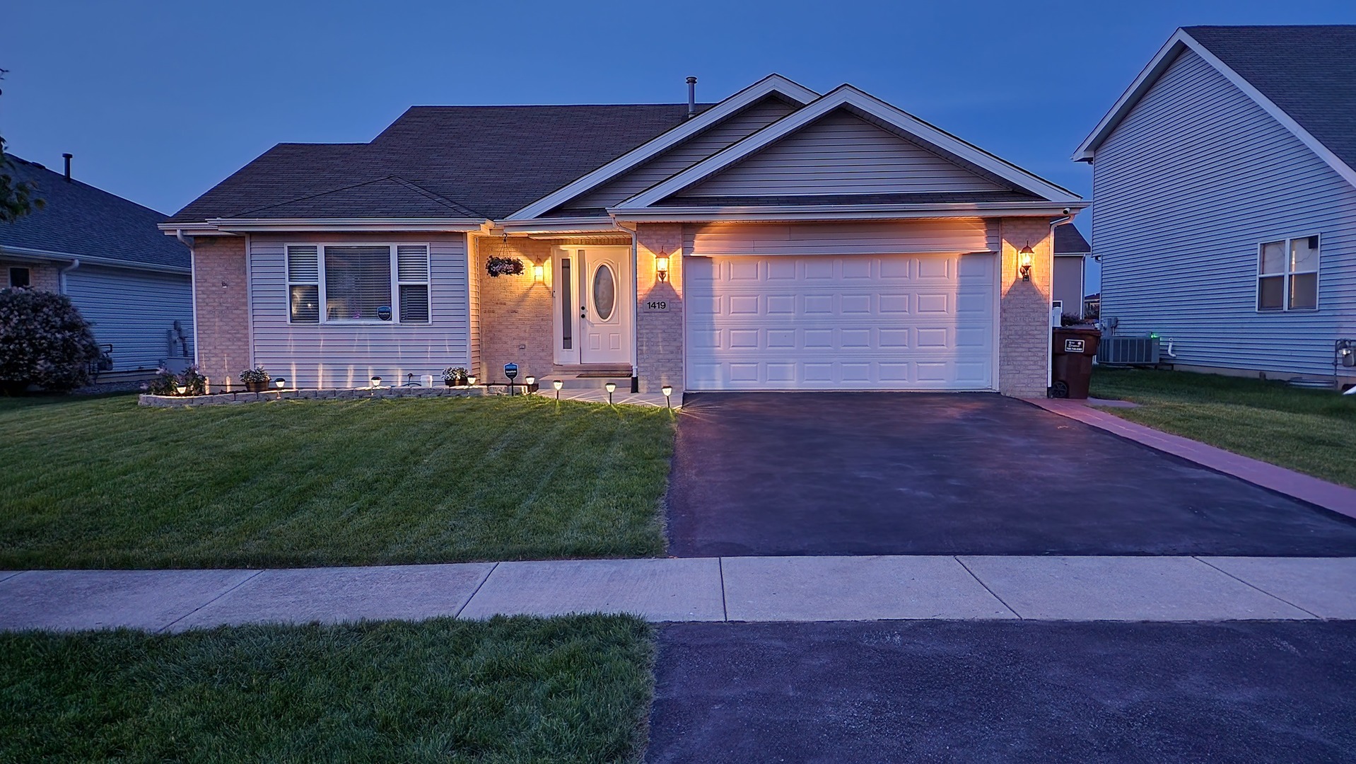 1419 Trailside Drive Beecher, IL 60401 - Photo 3 of 28 a front view of a house with a yard and garage