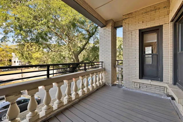 a view of balcony with wooden floor