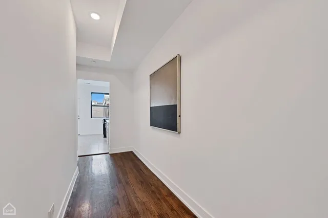 a view of hallway with wooden floor