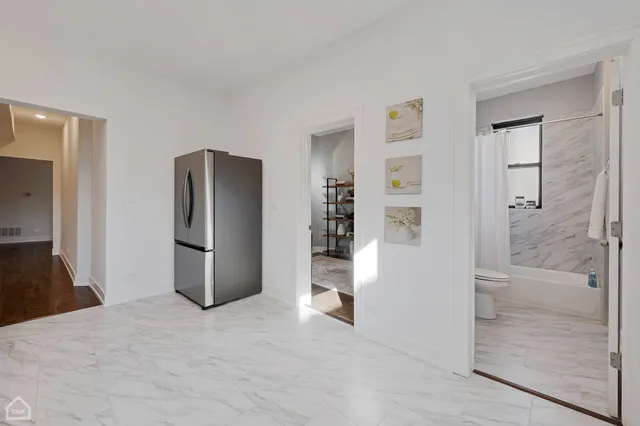 a view of kitchen and refrigerator