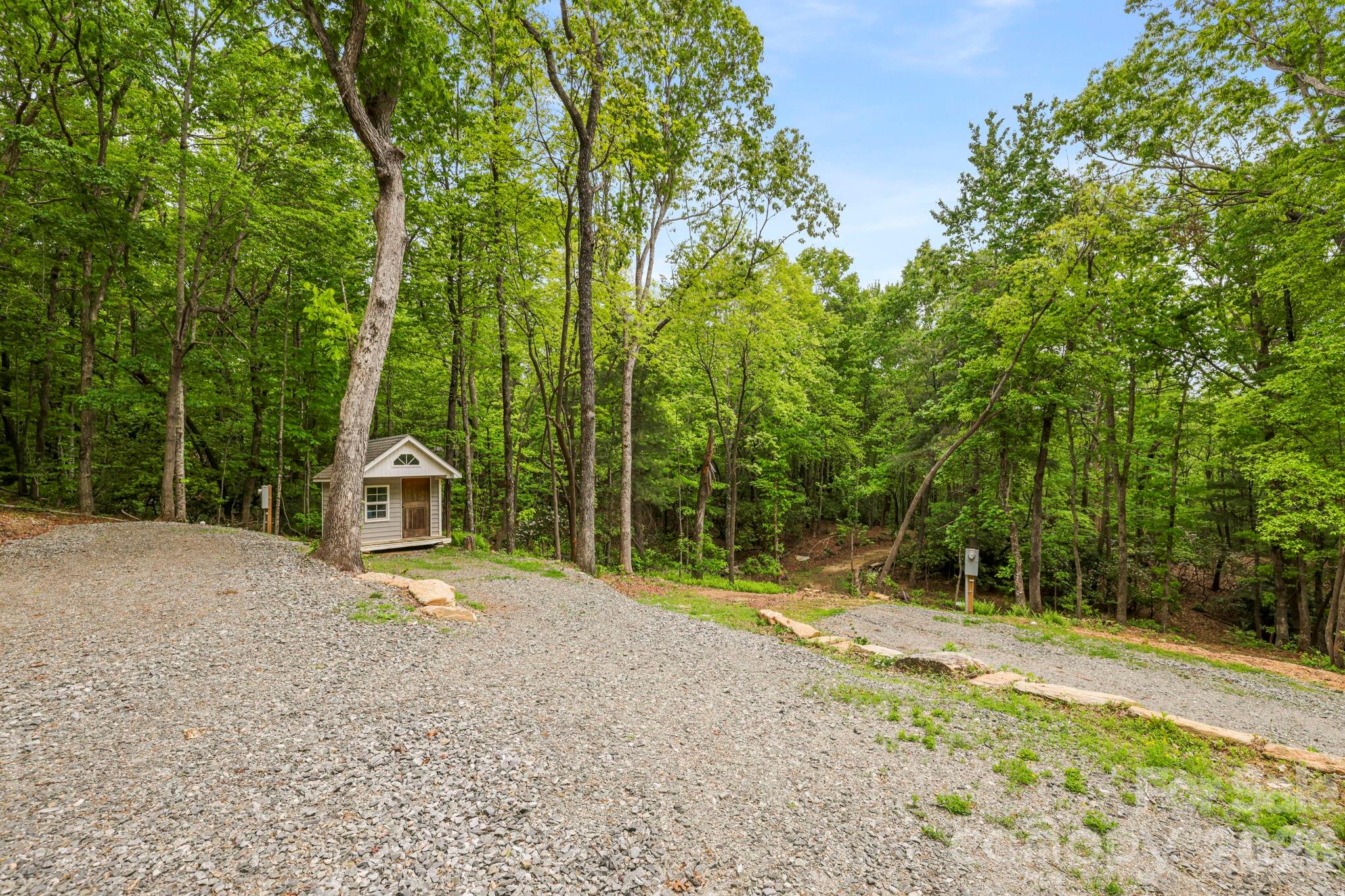 137 Bird Song Road, Unit 3 Penrose, NC 28766 - Photo 4 of 23 a view of a road with a wooden fence