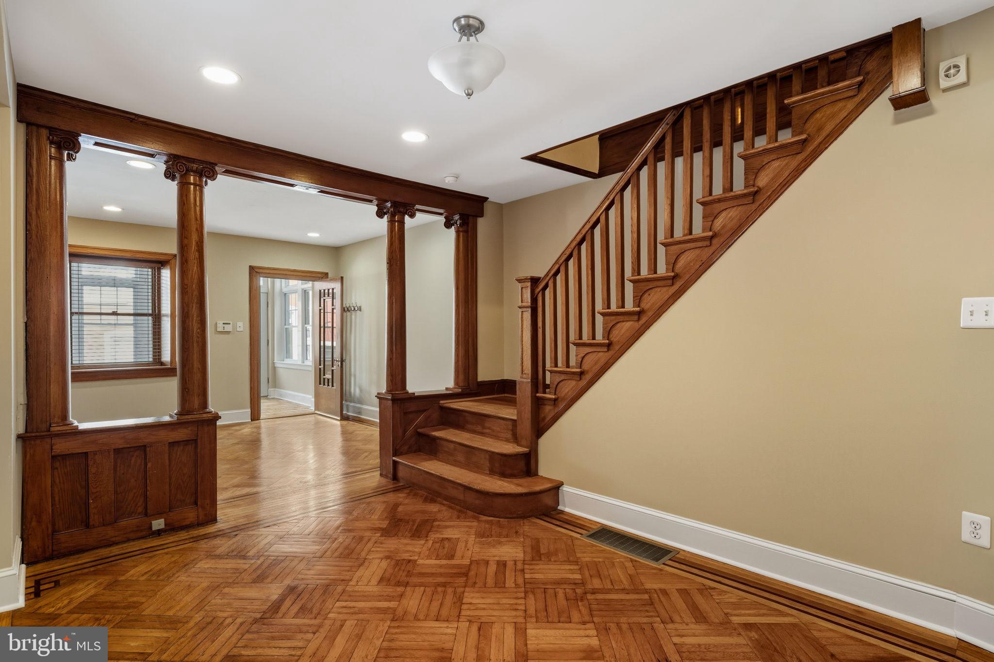 337 Carson Street Philadelphia, PA 19128 - Photo 15 of 36 a view of an entryway with wooden floor leading to a furnished livingroom and windows