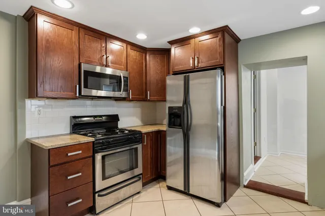 a kitchen with a refrigerator stove and microwave