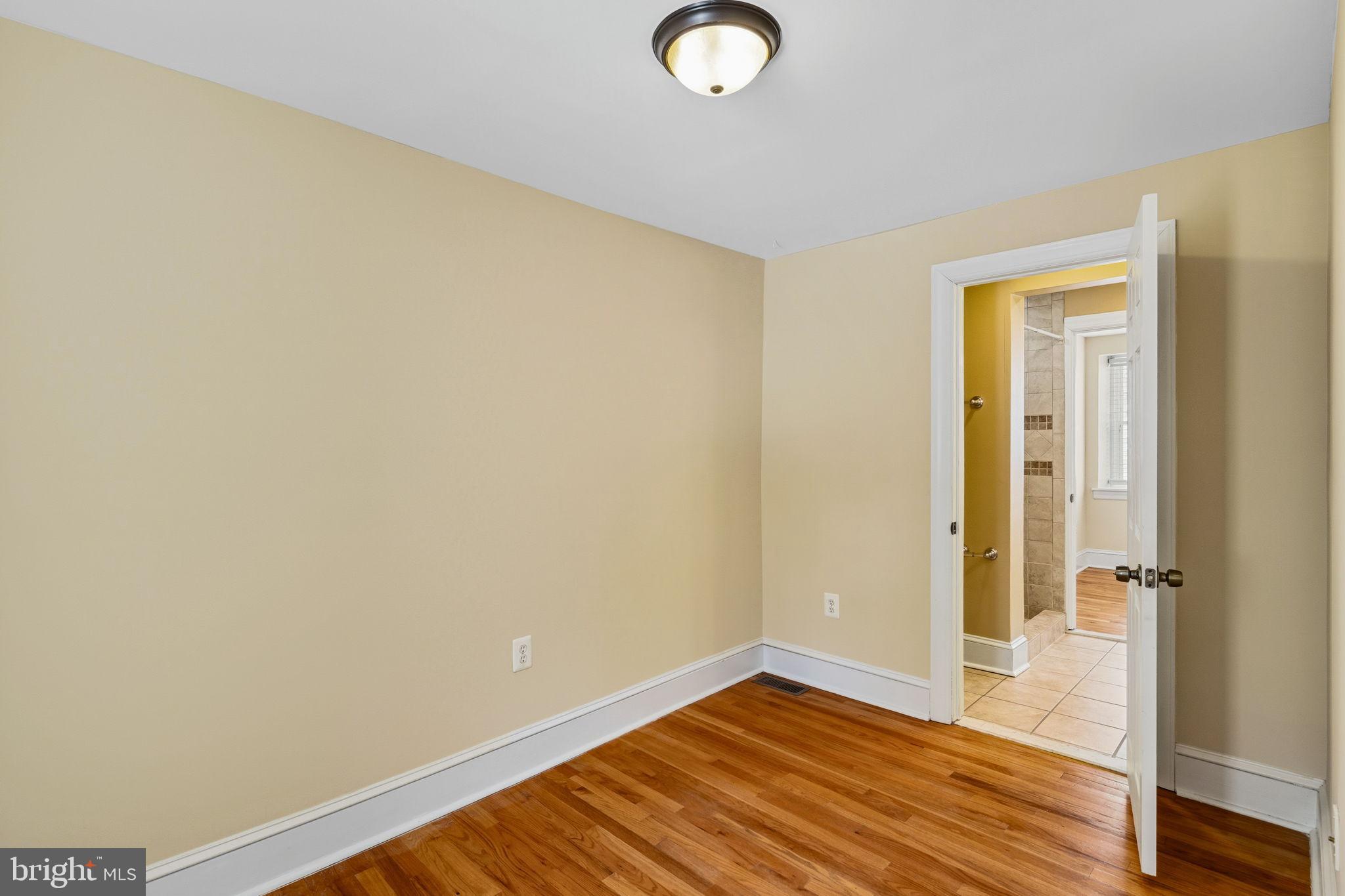 337 Carson Street Philadelphia, PA 19128 - Photo 25 of 36 an empty room with wooden floor and a window