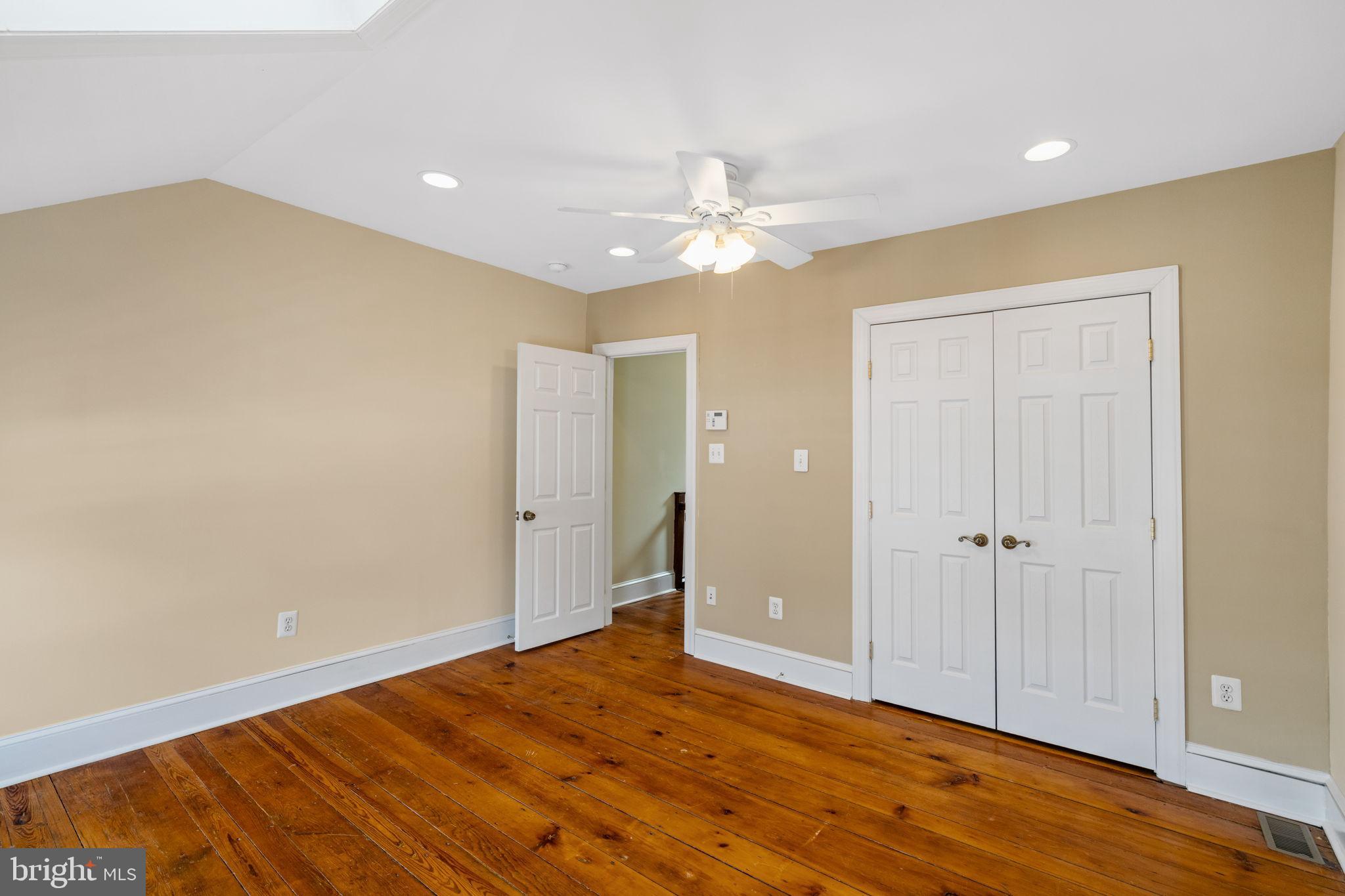 337 Carson Street Philadelphia, PA 19128 - Photo 28 of 36 an empty room with wooden floor and a ceiling fan