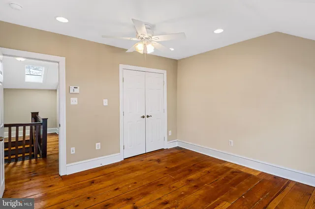 a view of a room with wooden floor and staircase