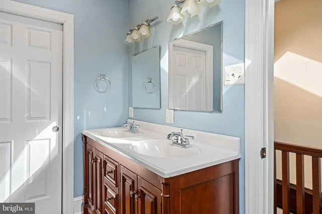 a bathroom with a sink vanity and a mirror