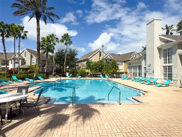 a view of a house with swimming pool and sitting area