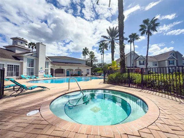 a swimming pool with outdoor seating yard and barbeque oven