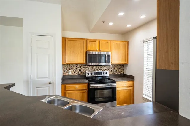 a kitchen with stainless steel appliances granite countertop a stove and a refrigerator