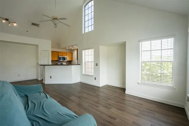 a view of a kitchen with microwave and windows
