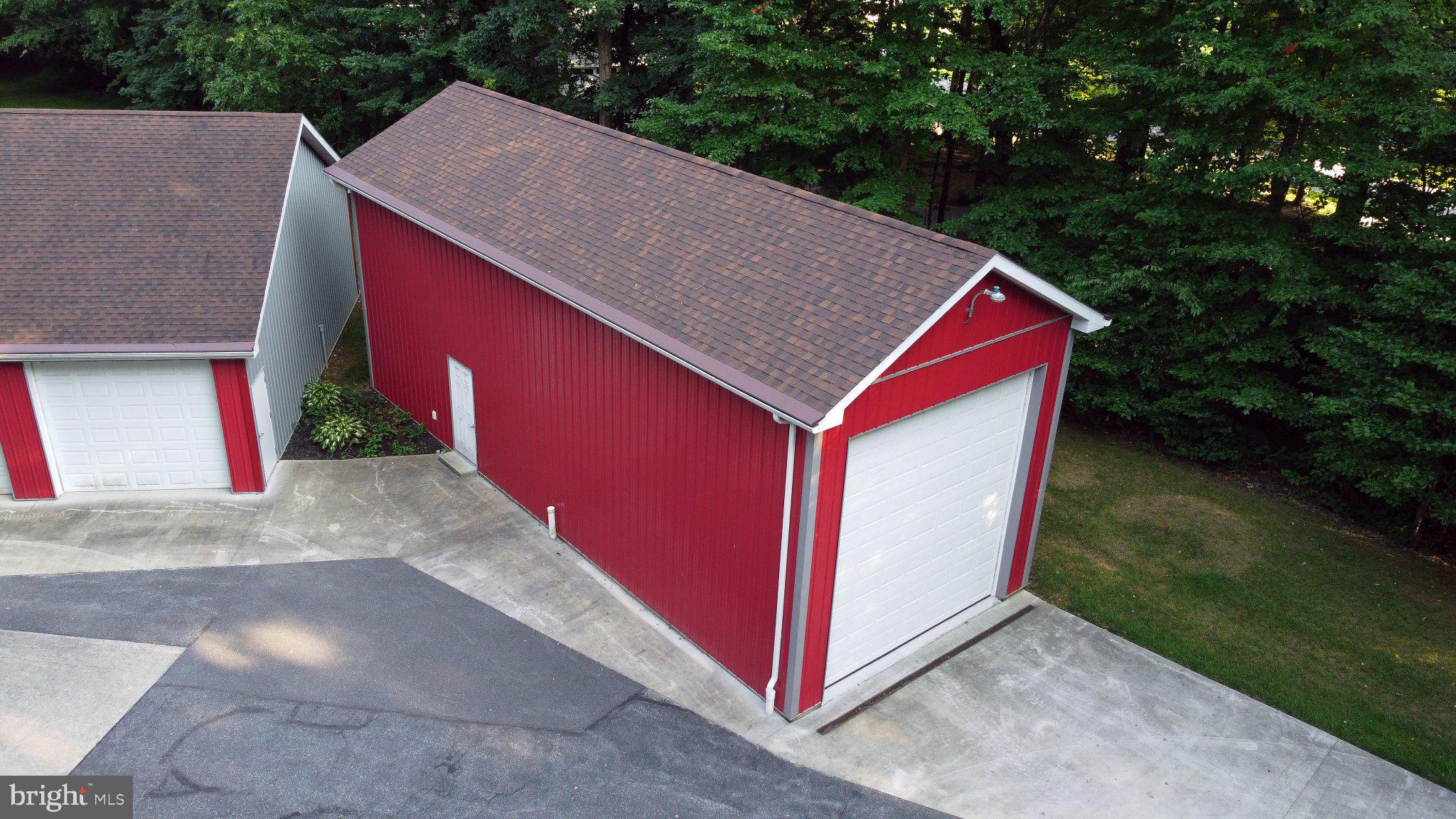 2597 Braddock Road Mount Airy, MD 21771 - Photo 27 of 61 Charming red storage building nestled in greenery.
