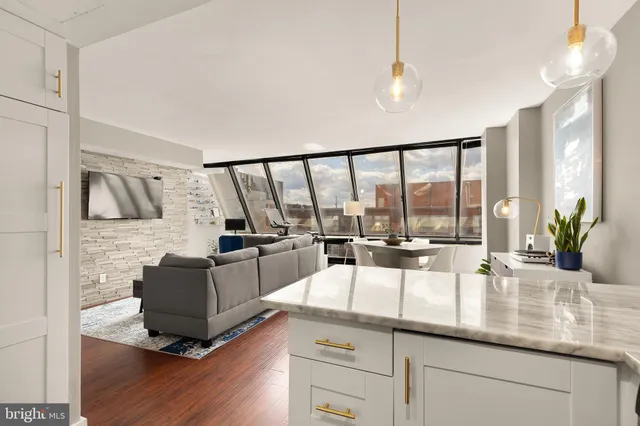 a living room with furniture and large windows