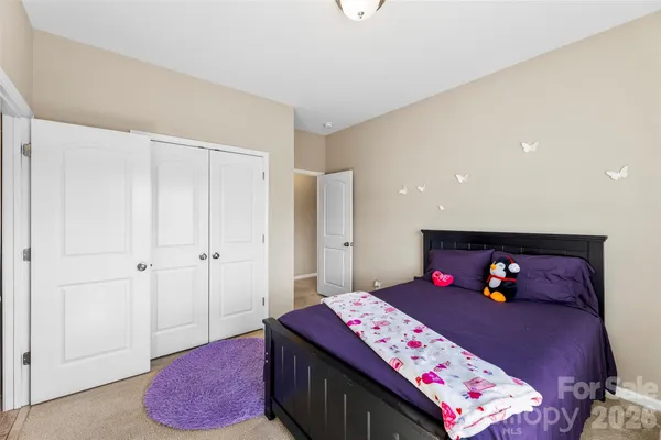 a bedroom with a bed and a table in it