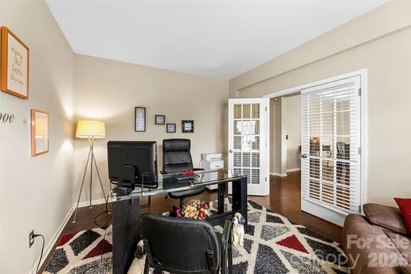a view of a workspace with furniture and a window
