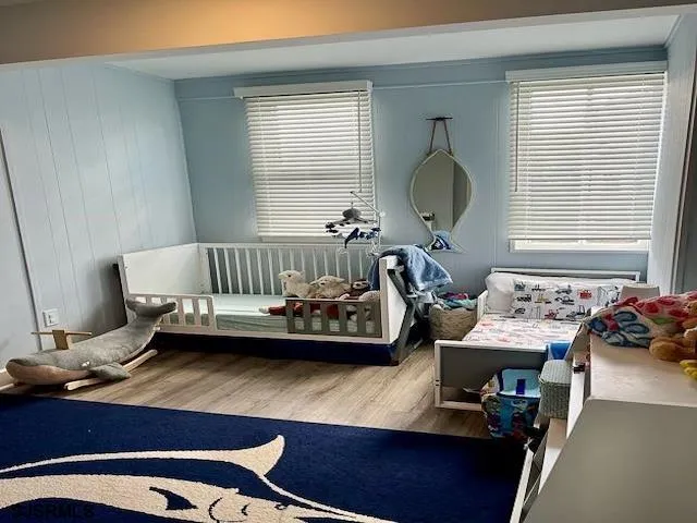 a living room with a bed and dresser