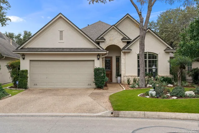 a view of a yard in front view of a house