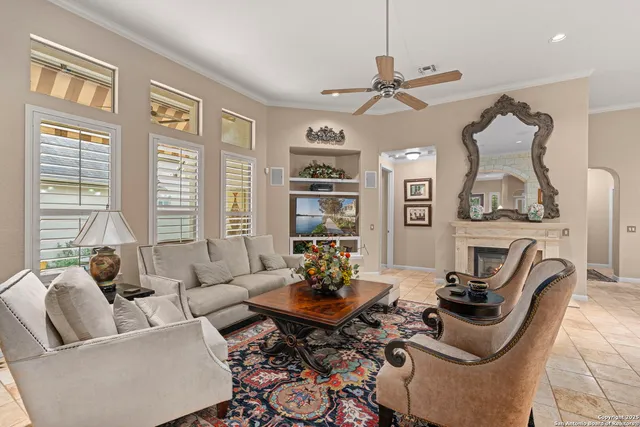 a living room with furniture ceiling fan and a window