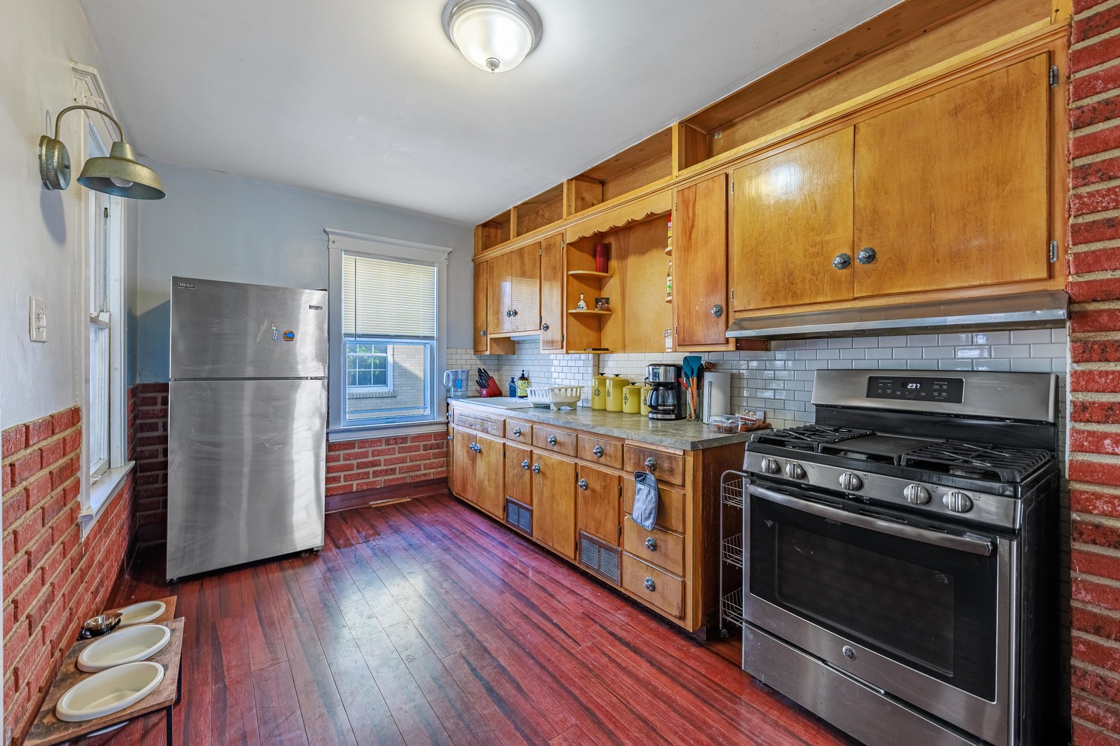 410 Repton Road Riverside, IL 60546 - Photo 9 of 30 a kitchen with stainless steel appliances a stove a refrigerator and a cabinets