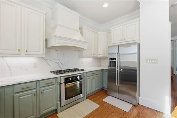 a kitchen with cabinets and stainless steel appliances