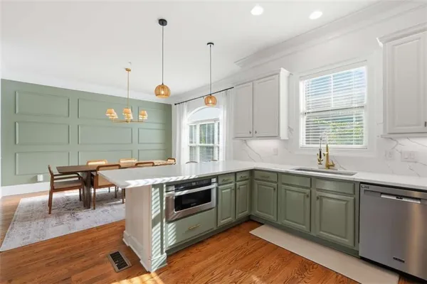 a kitchen with a sink stove and cabinets