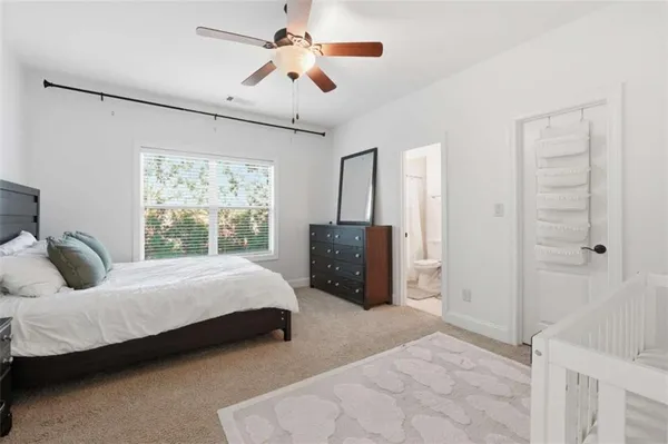 a bedroom with a bed dresser and a window