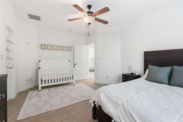 a bedroom with a bed and a ceiling fan