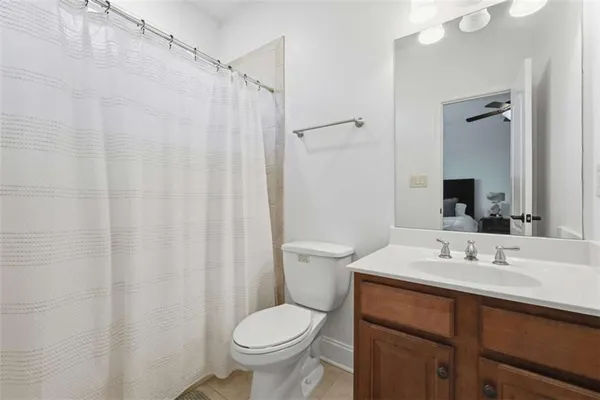 a bathroom with a sink a toilet and shower curtain
