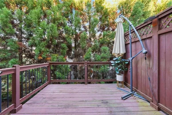 a view of a house with backyard and wooden deck