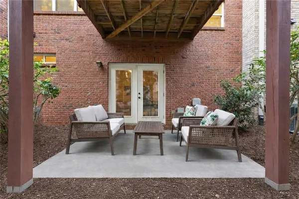 a view of a patio with couches table and chairs and potted plants