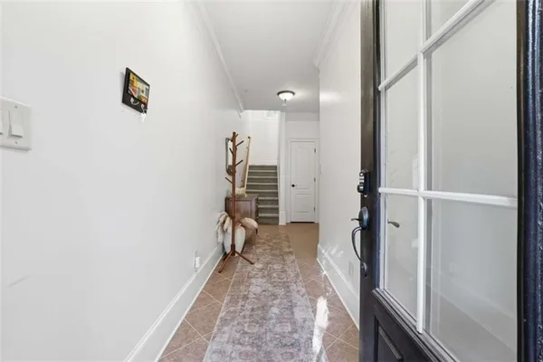a view of a hallway with wooden floor and staircase