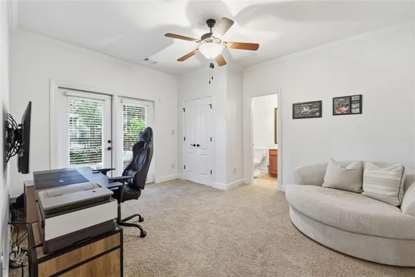 a view of a livingroom with workspace and a window